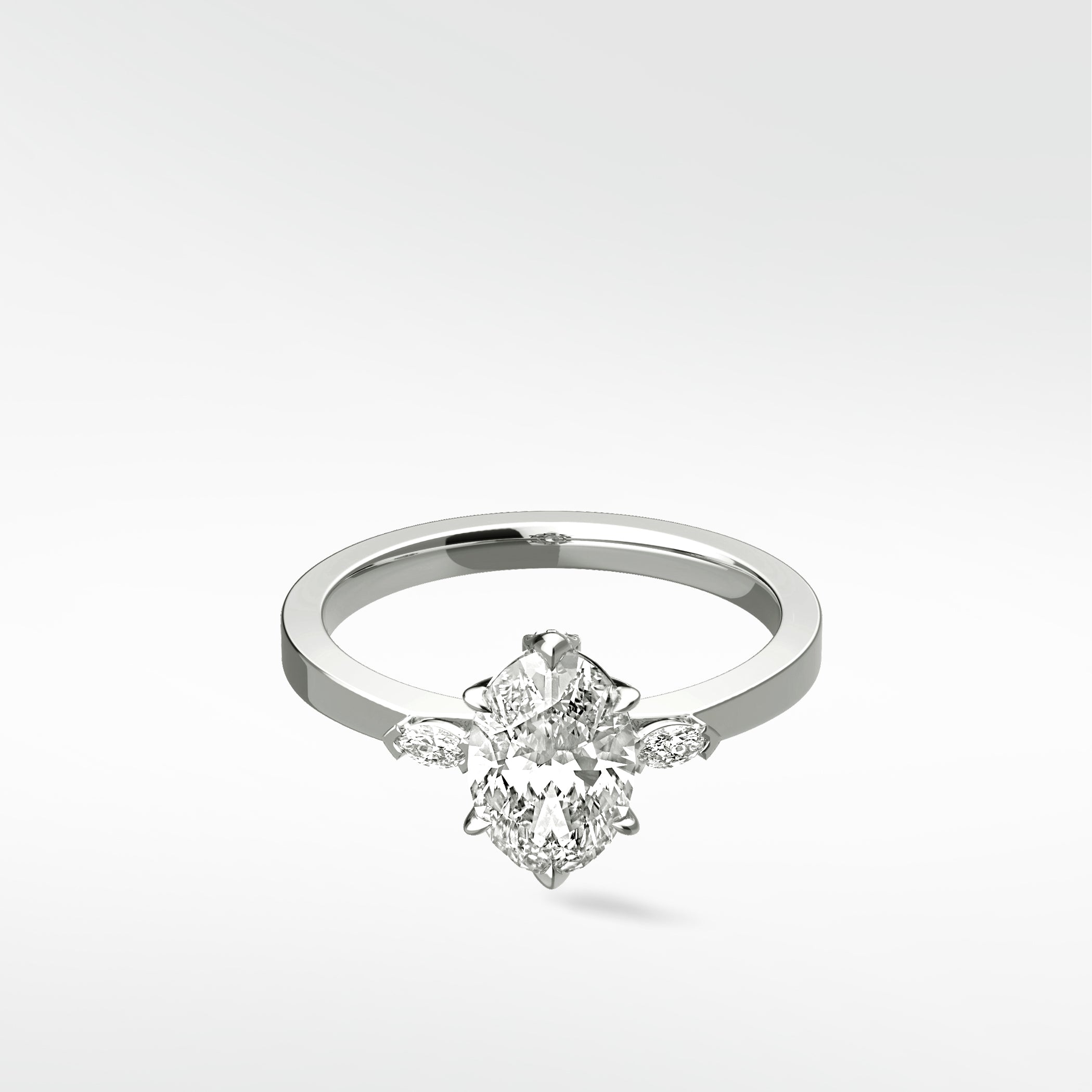 The Fern Engagement Ring with an oval diamond center stone and marquise accents on a platinum band.